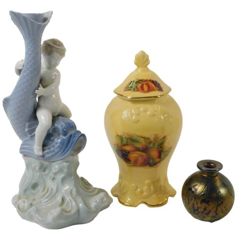 A Nao porcelain candlestick, modelled as a sea urchin riding a dolphin on waves, printed marks, 28cm high, together with an Aynsley Orchard Gold jar and cover, 22.5cm high, boxed, and a Maltese glass vase, of cylindrical form with flared neck, 8.5cm high.