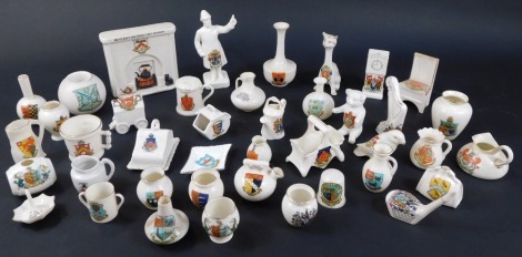 A collection of various crested china ornaments, to include W H Goss, Swan China, Arcadian China, and others, including traffic policeman, Goss match striker, ancient pots, thimble, etc. (40)