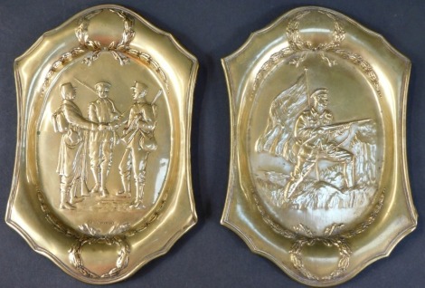 A pair of World War Two brass shaped oval trays, embossed with Troops in Alliance, and a British Soldier with Union Flag, with swags and wreaths, one stamped S & Co Copyright, 17cm x 11cm.