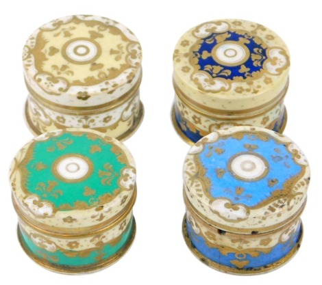 Four 19thC Staffordshire pottery rouge pots and covers, each of cylindrical form in differing colours, yellow, powder blue, navy blue and green, gilt decorated with scroll and foliate motifs, 4cm diameter. (AF)