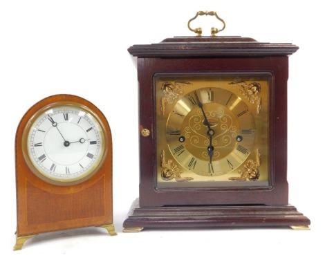 An oak cased Metamec mantel clock, the brass dial with circular chapter ring bearing Roman numerals, eight day with Westminster chime, cherub spandrels, with brass ring handle, the case 29cm high, together with an Edwardian domed mantel clock, the circula