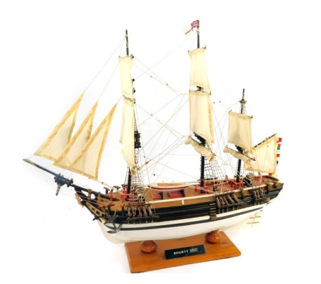 A scratch built model of a HMS Bounty, on wooden base, 63cm high.