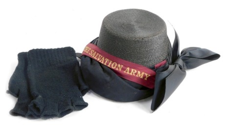 An early 20thC Salvation Army bonnet, with burgundy Salvation Army band and large bow, boxed, together with a pair of black wool fingerless gloves.