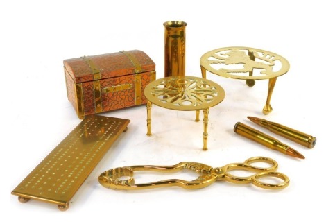 A group of brassware, to include trivet, cribbage board, tea canister modelled as a chest, shell cases, etc.