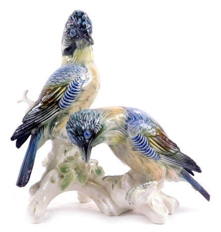 A Karl Ens porcelain figure group depicting two birds on tree branch, faded printed marks to underside, 30cm high.