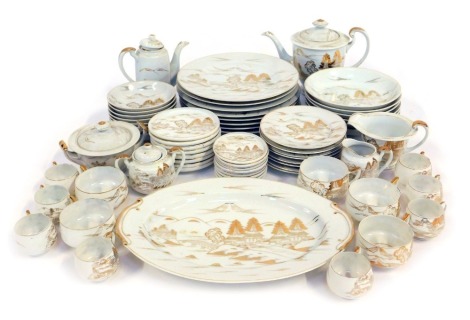 A Japanese porcelain part tea and dinner service, each piece decorated in gilt with scenes depicting buildings, etc., gilt heightened against a white ground, to include teapot, dinner plates, breakfast bowls, teacups and saucers, etc.