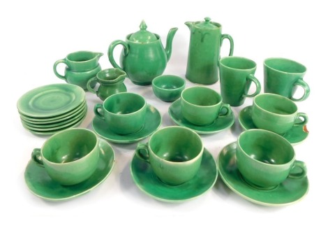 A C H Brannam Ltd Barnstaple studio pottery part tea service, green glaze, to include teapot, hot water jug, various teacups and saucers, etc., impressed marks to underside.