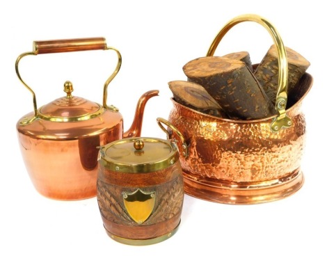 A group of copper and brass ware, comprising kettle, 29cm high, hammered copper coal scuttle with brass handle, and an oak biscuit barrel, with brass mount. (3)