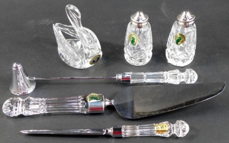 A group of Waterford crystal, comprising salt and pepper shakers, candle snuffer, cake slice, letter opener and swan shaped trinket dish, each with paper labels.