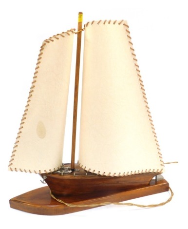 A treen table lamp, modelled as a yacht, with two sails, 46cm high.