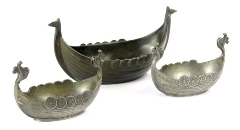 A Danish Just Andersen bronze model of a Viking long boat, D1109 to underside, impressed marks, 11cm wide, together with two Handstopt pewter long boats, possibly salts, 7cm wide. (3)