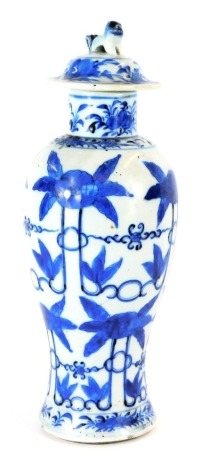 A 19thC Chinese vase and cover, of baluster form, decorated with blue flowers, against a white ground, lid with Dog of Fo finial, 32cm high.