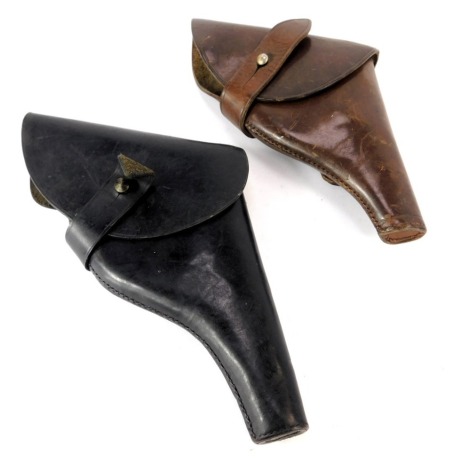 Two leather pistol holsters.