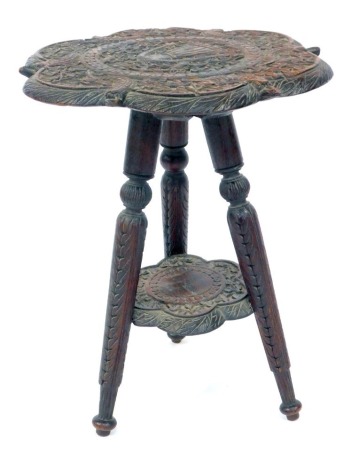 An Eastern hardwood carved teak tripod table, 46cm high, 39cm diameter.