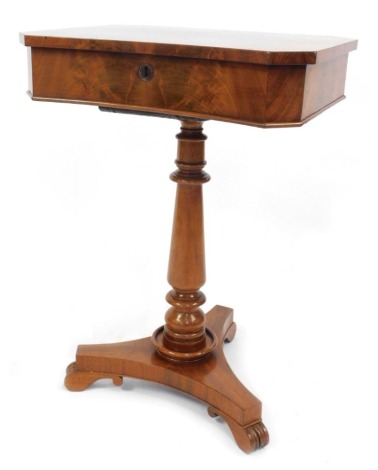 A Victorian flame mahogany work table, with cross banded and shaped top, revealing a fitted interior, baluster turned stem, trefoil platform base with scroll feet, 72cm high, 52cm wide.