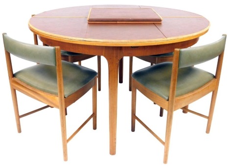 A McIntosh teak circular extending dining table, together with four chairs, table 130cm diameter. The upholstery in this lot does not comply with the 1988 (Fire & Fire Furnishing) Regulations, unless sold to a known exporter or upholsterer it will be cut 