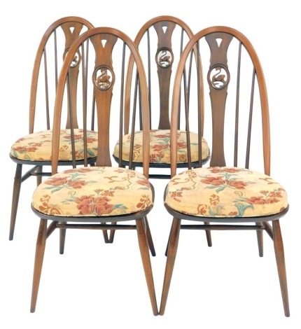 A set of four Ercol high back dining chairs, with swan splats.