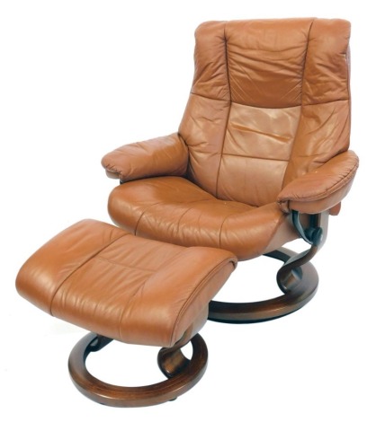 A Stressless reclining armchair and stool. (2)