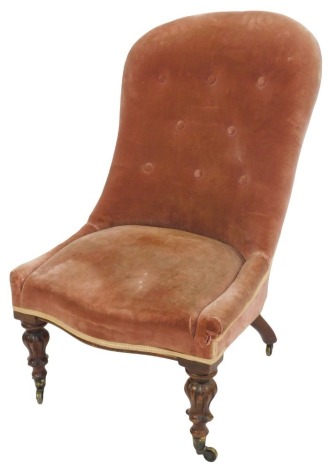 A Victorian nursing chair, with buttoned velvet upholstery.