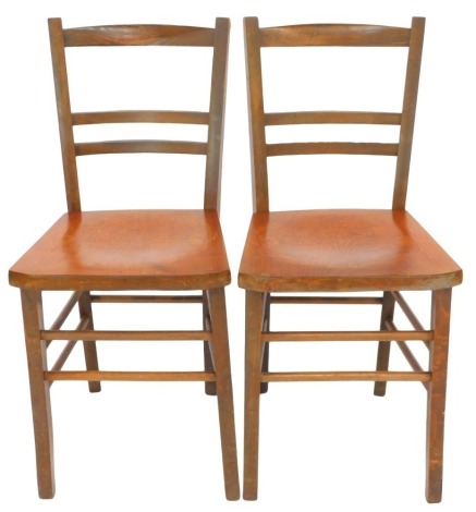 Two Edwardian beech kitchen chairs, with bentwood seats.