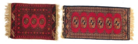 A Persian red ground rug, decorated with three roundels within multiple borders, 62cm x 52cm, together with a further rug 47cm x 89cm.