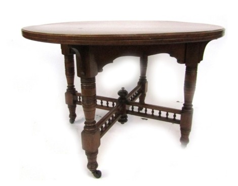 An Edwardian walnut breakfast table, the circular top with a moulded edge raised on four turned legs united by an X shaped stretcher, on castors, 75cm high, the top 110cm diameter.