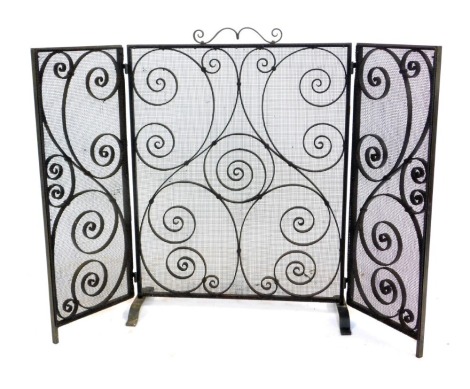 A wrought iron triple folding fire guard, with scroll work design, 72cm high, 101cm wide.