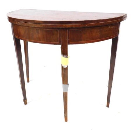 A George III mahogany demi-lure tea table, with box wood stringing, on square tapered legs, 73cm high, 92cm wide. (AF)