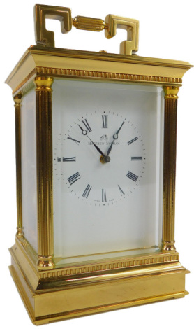 A 20thC brass carriage clock, the square enamel dial bearing Roman numerals for Matthew Norman, eleven jewel unadjusted Swiss made movement for Matthew Norman of London, numbered 1751A, the case of shaped ring handle moulded top above four reeded columns 