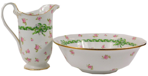 A Grimwades Winton ware pottery wash jug and bowl, decorated with pink roses and plaited grey and green bow, on a white ground, gilt heightened, printed marks, the wash jug 31cm high.