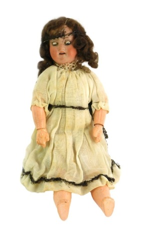 An early 20thC Armand Marseille doll, in cream embellished dress, impressed marks to head Armand Marseille 390, A4½M, 26cm high.