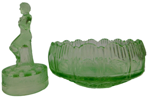 An Art Deco style moulded green glass flower bowl, central section modelled as a female nude seated on tree bough, and circular bowl, the base impressed with roses, leaves, etc., 19cm diameter.