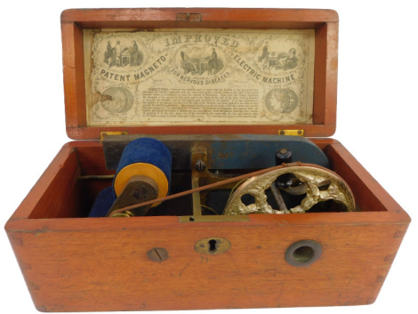 A late 19thC patent Magneto Improved Electric Machine, for nervous diseases, contained in an oak case, with paper label underside lid, 26cm wide.