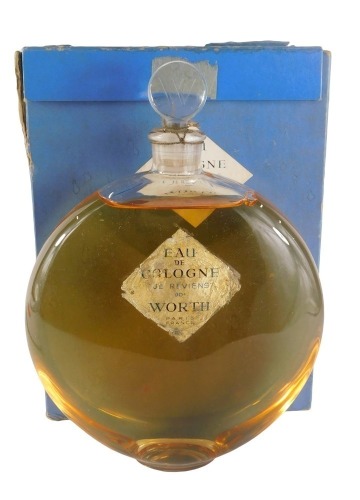 A large unopened bottle of Worth eau de Cologne, 'JE Reviens', in sealed circular bottle, with original box numbered 108, the box 24cm x 19cm.