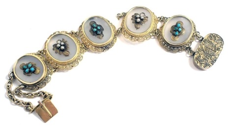 A Chinese filigree five sectional bracelet, each of oval form set with moonstone and raised seed pearl and turquoise, on a fret work border, on two row chain with scarab type clasp, yellow metal with Chinese markings to clasp, 18.5cm long, 32.4g all in. (