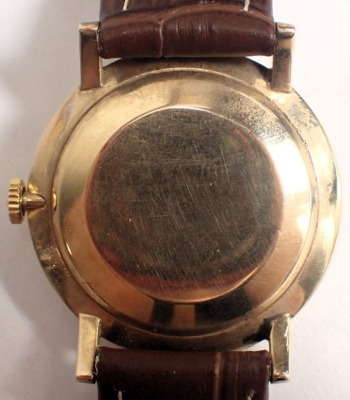 An Omega 9ct gold cased gent's wristwatch, with a silvered numeric dial and twenty one jewel movement, on a later brown leather strap, the dial 3.5cm diameter, 31.8g all in, boxed. - 3