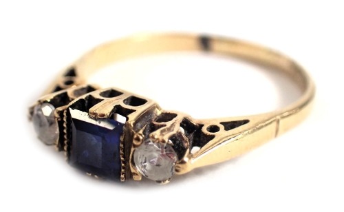 A 9ct gold Art Deco style dress ring, set with central sapphire and flanked by two CZ stones, in a raised basket setting, ring size O, 2.4g all in.