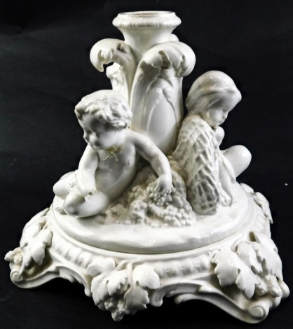 A Minton stand for a centrepiece, modelled with putti, grapes, fishing net, etc., with separate pedestal, 20cm high. (AF)