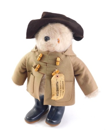 A plush model of Paddington Bear, with brown duffel coat, hat, Dunlop wellies, and label, 49cm high.