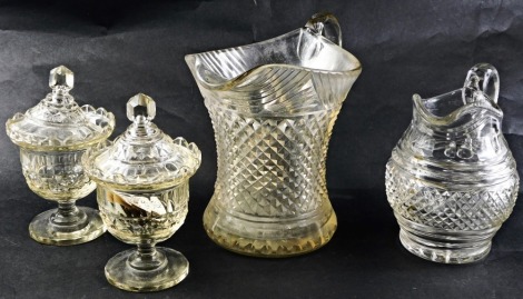 A pair of late 19th/early 20thC small cut glass bonbonieres, 17cm high, a hobnail cut glass jug, and a larger jug. (4)