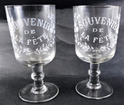 A pair of French large souvenir goblets, with engraved decoration Souvenir de la Fete, on a knopped stem with plain foot, 21cm high.