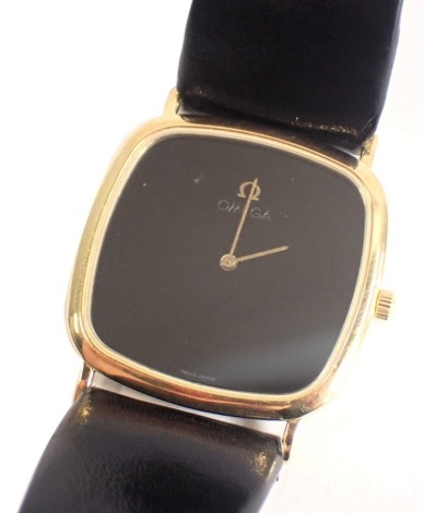 An Omega Deville gentleman's wristwatch, with a blackened square watch face and gold hands, 2.5cm diameter, on a black leather strap.