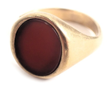 A 9ct gold signet ring, with oval orange agate in rub over setting, on a plain band, ring size T½, cut, 7.2g all in. (AF)