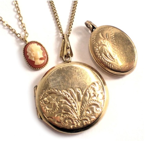 Two pendants and chains, comprising a cameo pendant on fine link neck chain stamped 375, a further circular locket with engine engraved decoration on fine link neck chain, and a 9ct gold oval locket, 8.8g all in.