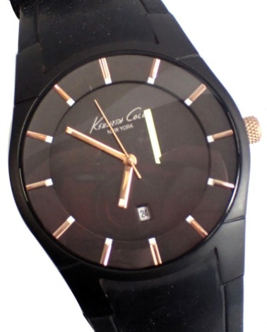 A Kenneth Cole gentleman's wristwatch, in stainless steel back and blackened face, with gold coloured hands, and battern markers, with date aperture, on black rubber bracelet, numbered U54-09 KC1621, the dial 4cm diameter, boxed.