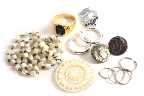 A group of costume jewellery, comprising mother of pearl pendant, pair of hoop earrings, and umbrella costume jewellery signet ring. (a quantity)