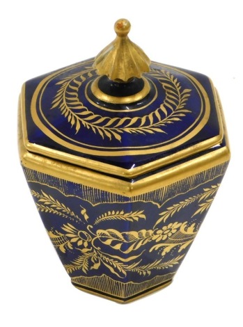 A Royal Crown Derby hexagonal jar and cover, decorated in gilt with flowers and leaves on a cobalt blue ground, printed mark in red to underside, 10cm high.