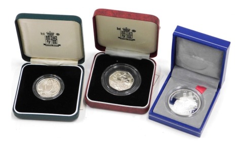 A D-day silver proof fifty pence coin, a French limited edition silver coin, and a WWII silver proof two pound coin. (3)