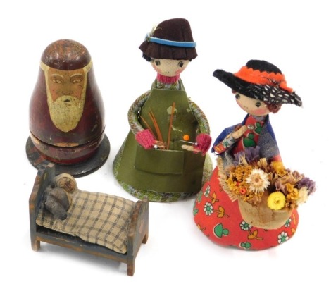 A small set of Russian dolls, the largest being Father Christmas, 9cm high, two costume dolls, and a miniature crib with two children. (4)