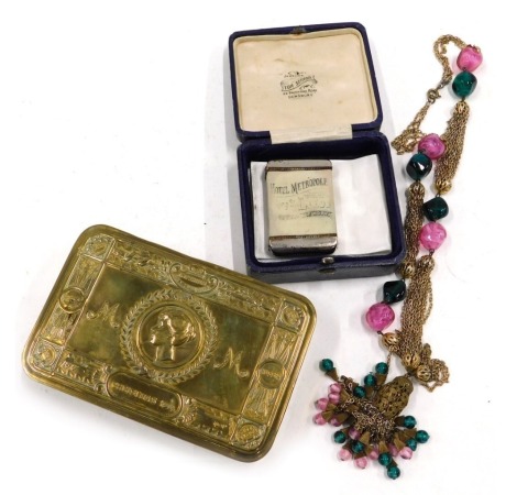 A First World War brass Christmas tin, Hotel Metropole Leeds advertising Vesta case, and a costume necklace.